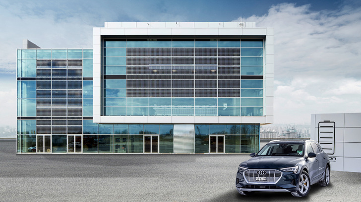Die Solarmodule fügen sich als zentrales Element perfekt in die Glasfassade ein. - © Audi AG
