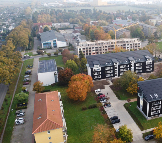Ein Blick auf die Plattenbauten in Aschersleben: Die vorderen beiden Gebäude wurden schon saniert. Der hintere Plattenbau soll Ende 2025 bezugsfertig sein.