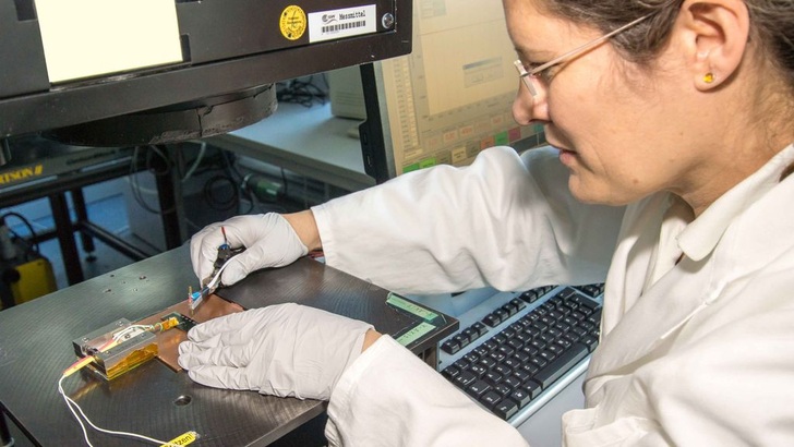 Forscherin bereitet Solarzellen für die Messung unter dem Sonnensimulator vor.