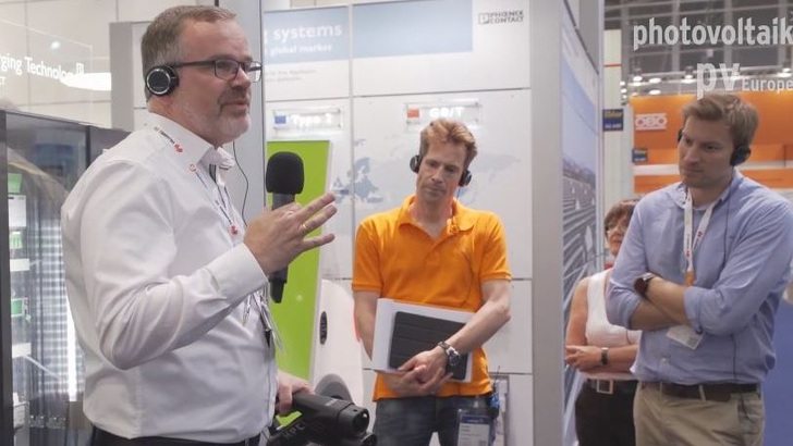 Thomas Oesselke von Phoenix Contact präsentiert einen Hochleistungsladestecker.